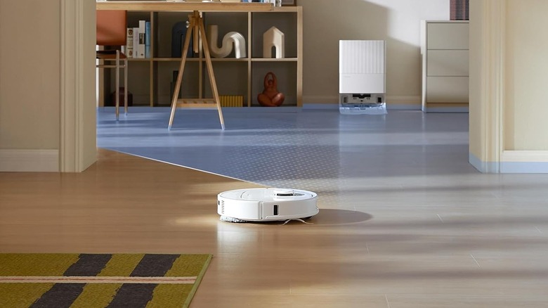 A roborock robot vacuum in action on wooden flooring