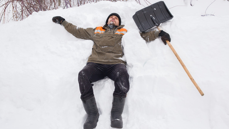 Person collapsing in the snow while shoveling