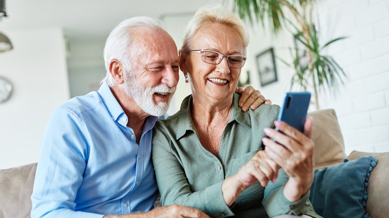 A senior couple holding a smartphone