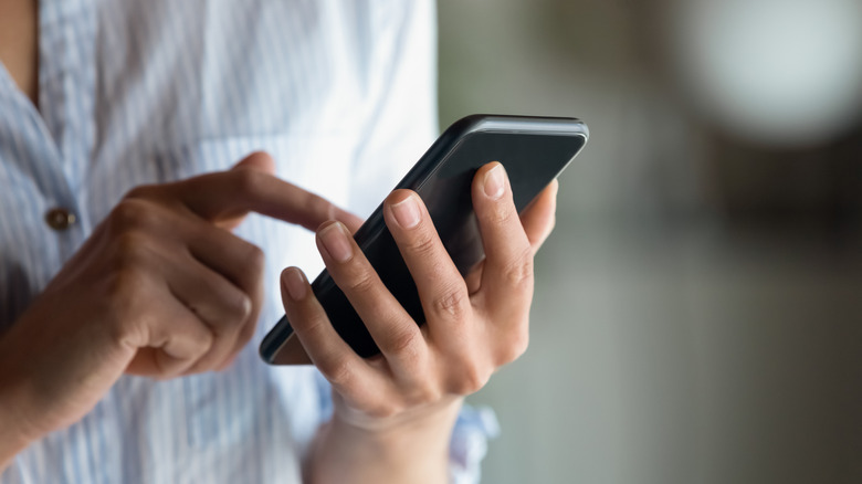 Person holding smartphone in hand