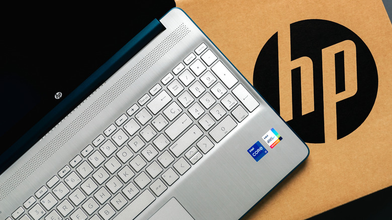An open HP laptop on top of a box with an HP logo