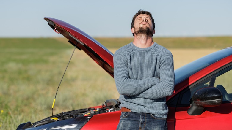 Man's car breaks down by the side of the road