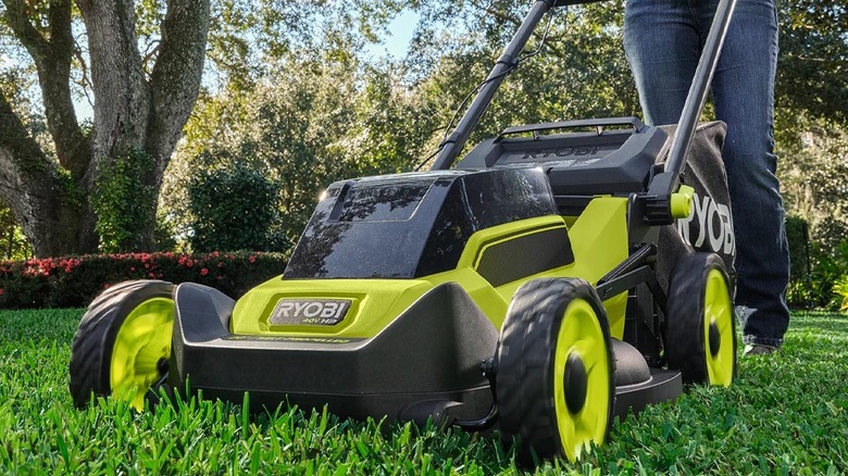 Ryobi RY401170VNM being pushed in the yard