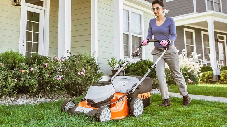 Woman pushing Stihl RMA 510 in frontyard