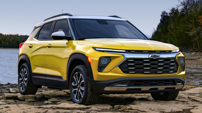 Yellow Chevrolet Trailblazer parked next to a lake