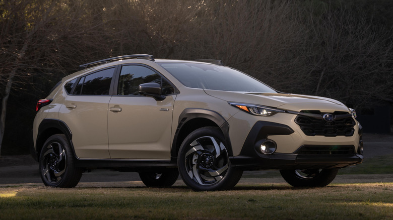 Beige Subaru Crosstrek Hybrid parked on grass