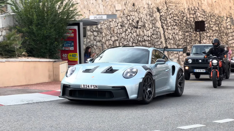 A front end shot of Alex Albon driving his Porsche GT3 RS through Monaco