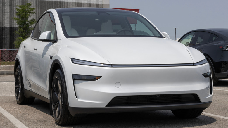 A white Tesla Model Y in a parking lot.