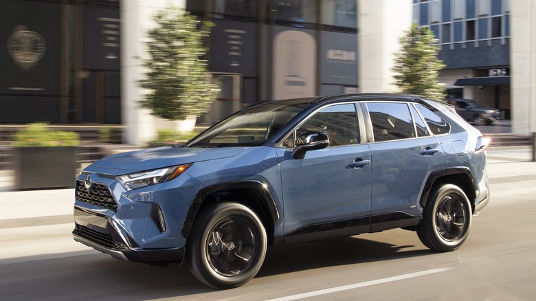 2022 Toyota RAV4 driving in city, left-side view