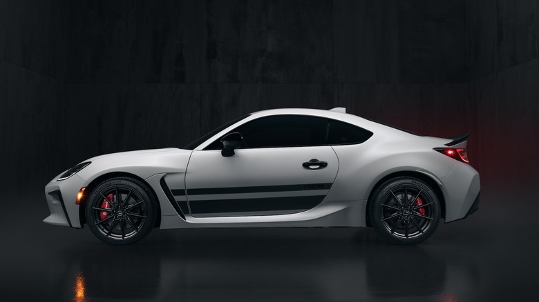 Side profile shot of the 2024 Toyota GR86 Trueno edition in studio with black background.