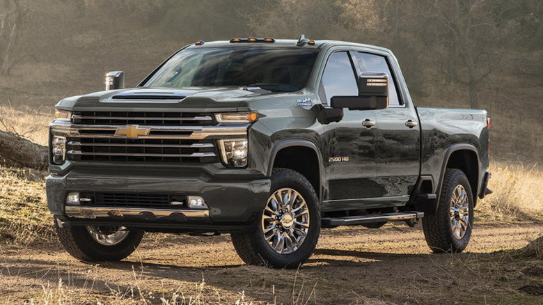 Green Chevrolet Silverado 1500 overlooking a dirt road