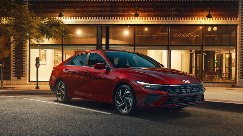 Red 2025 Hyundai Elantra model in front of a cafe