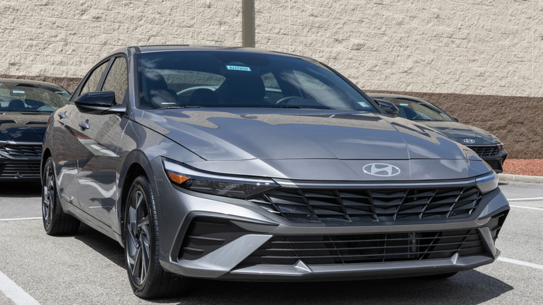 A grey Hyundai Elantra SEL in a parking lot, with two others behind it.