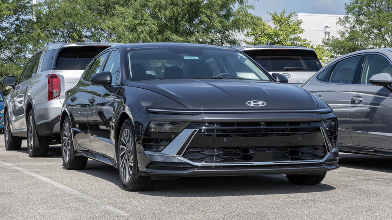 A grey 2025 Hyundai Sonata on display, parked outside in a dealership lot.