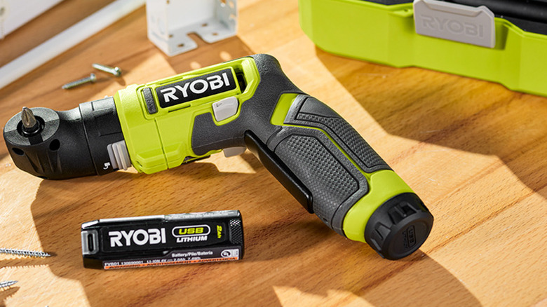 a Ryobi USB lithium screwdriver and battery on a wooden bench