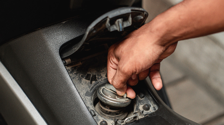 Person removing gas cap
