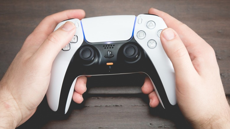 Person holding PS5 DualSense