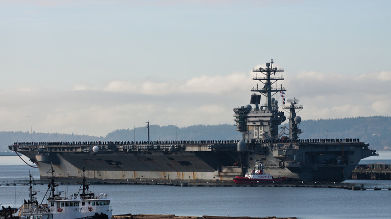The USS Nimitz docked at a harbor.