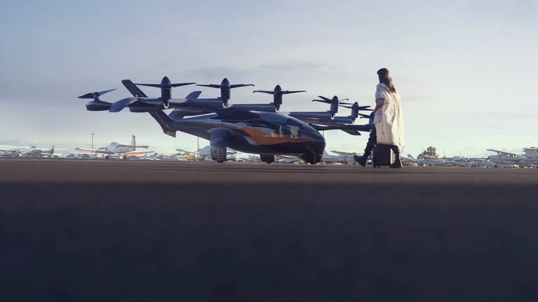 Person standing next to Archer's Midnight flying air taxi
