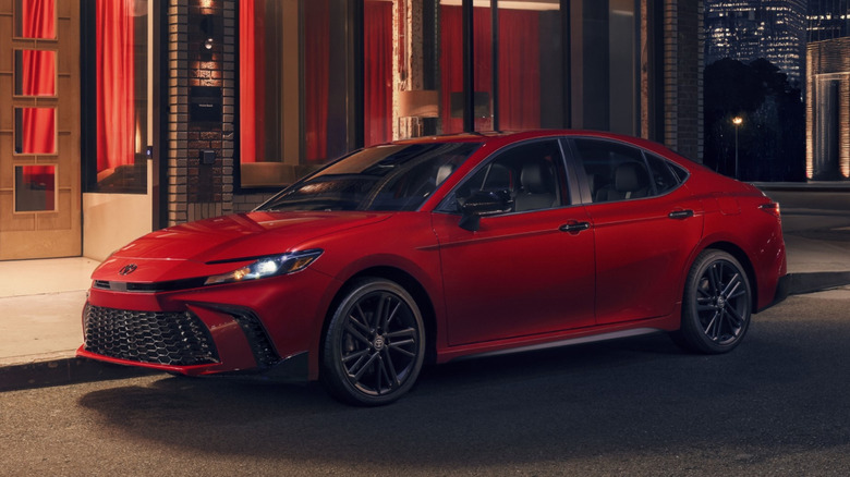 Front left view of  red toyota camry parked on city street