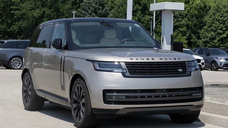A silver Land Rover Range Rover parked at a dealership.