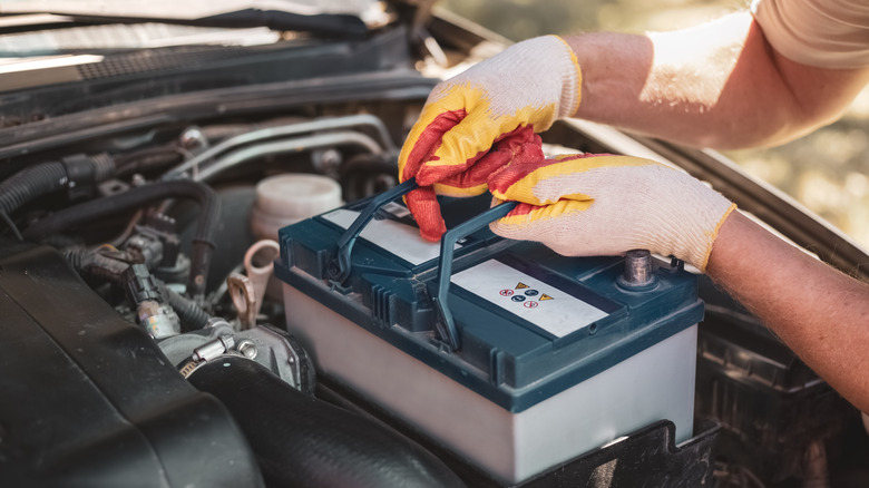 Mechanic installing a new car battery