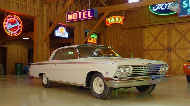 1962 Chevy Impala SS badge in garage with neon lights