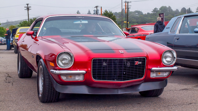 Front view of a red 1970s Chevrolet Camaro Z28 parked at a car show