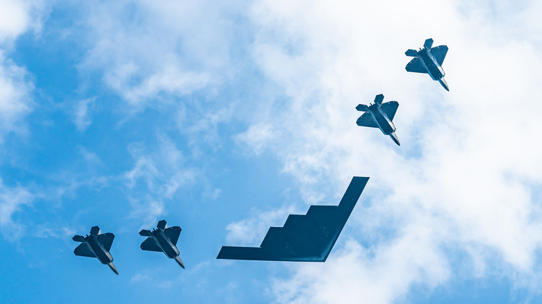 B-2 Spirit flyover flanked by fighter jets