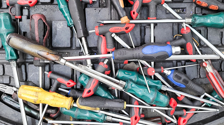 A collection of screwdrivers on a tool case