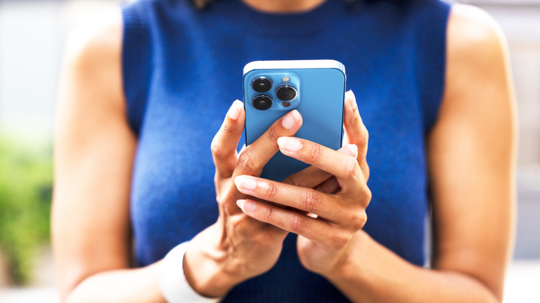 A girl using an iPhone Pro model.