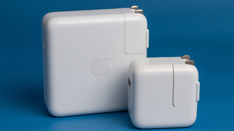 Apple charging adapters against a blue background.