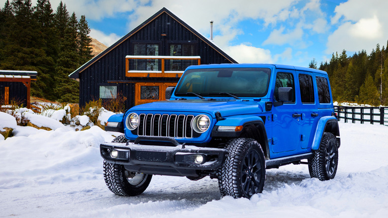 2025 Jeep Wrangler 4xe parked in front of cabin