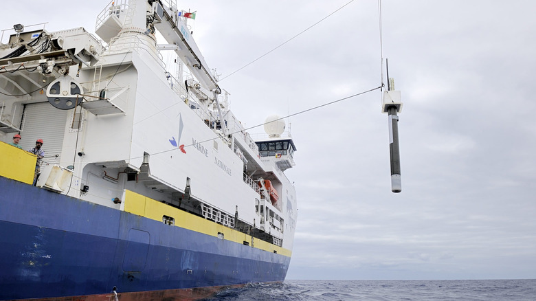 Biogeochemical (BGC)-Argo float being lowered into the ocean from a research ship