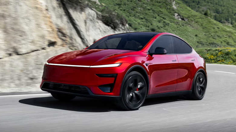 red Tesla Model Y Performance driving down a mountain road