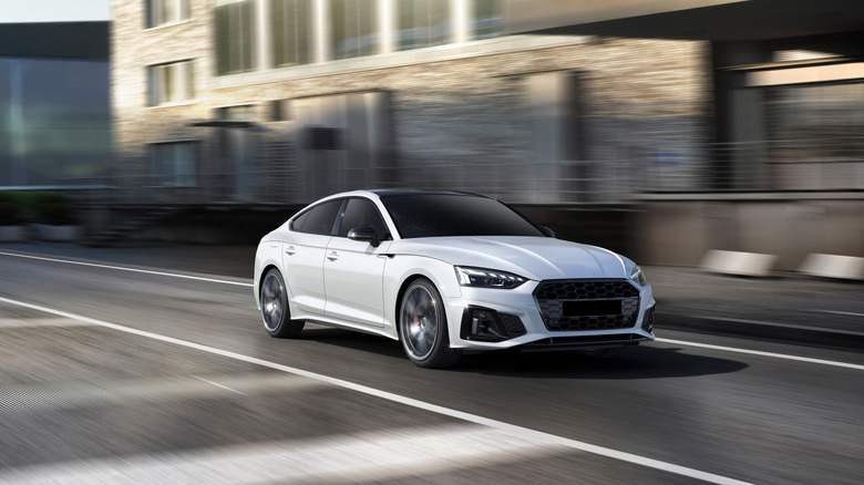 A white speeding car on a road