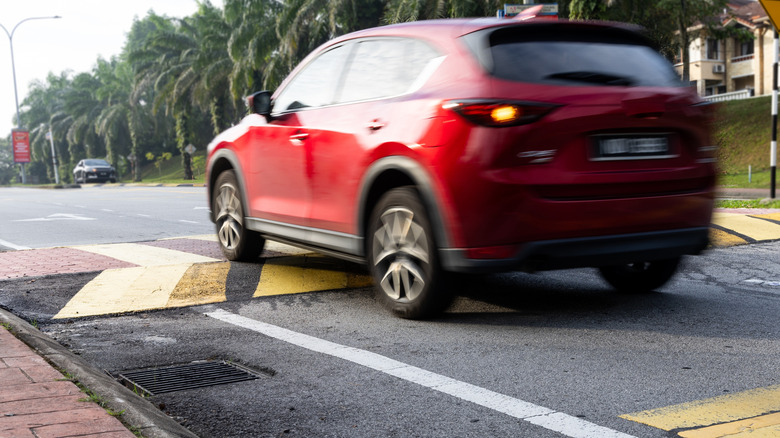 SUV driving over speed bump