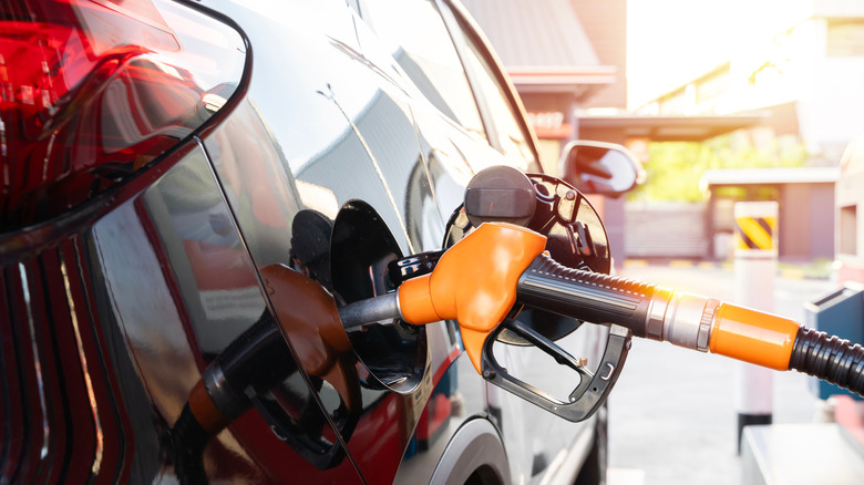 Close-up of a fuel nozzle in a car's fuel tank intake