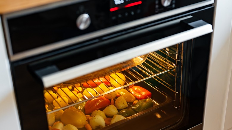 Assortment of vegetables cooking in an oven