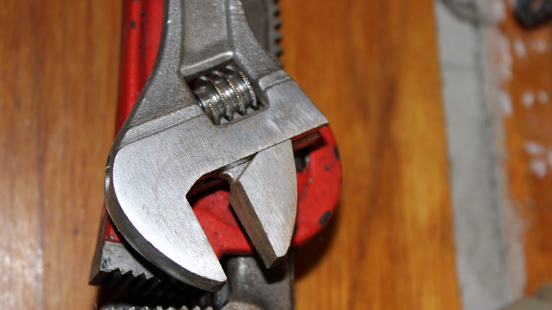 A crescent wrench on a monkey wrench