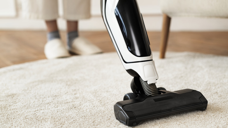 Close up of a vacuum cleaner on a rug.