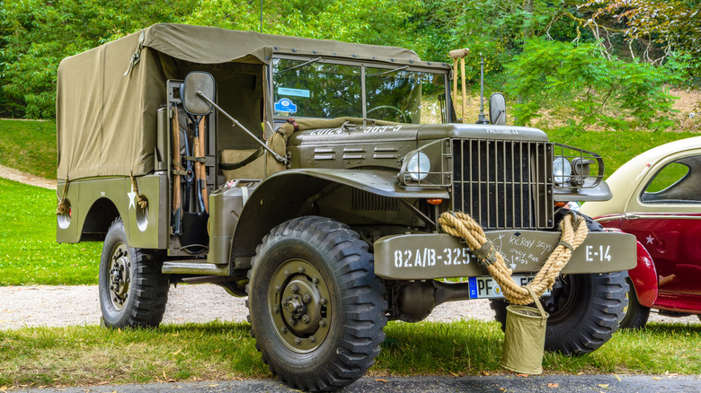 A green khaki Dodge WC-51 military on display with vegetation in the background