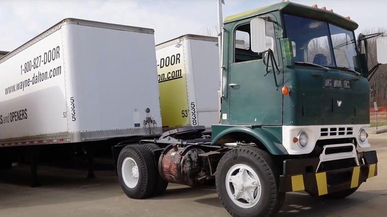 GMC Crackerbox truck backed up to trailer
