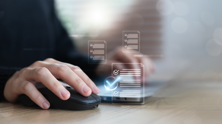 Hand on mouse with document icons overlaid