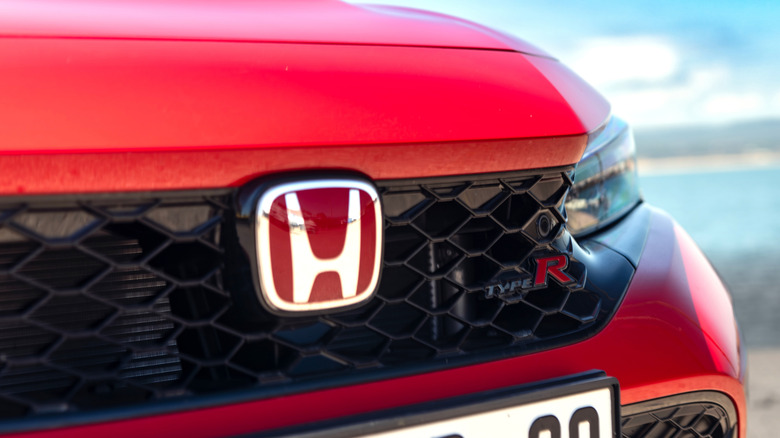 Close-up of Honda logo on a red Honda Civic Type R