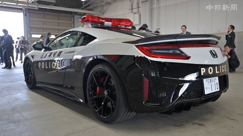 Rear quarter view of second-generation Honda NSX police interceptor in Mie Prefecture livery in paddock garage at Suzuka Circuit