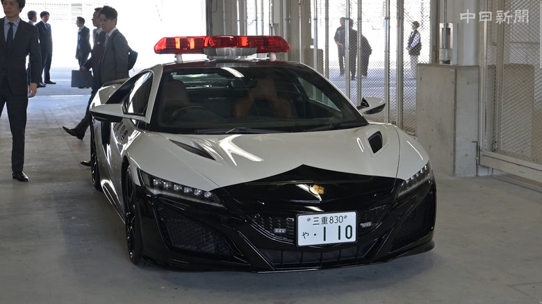Second-generation Honda NSX police interceptor in Mie Prefecture livery in paddock garage at Suzuka Circuit, front-view