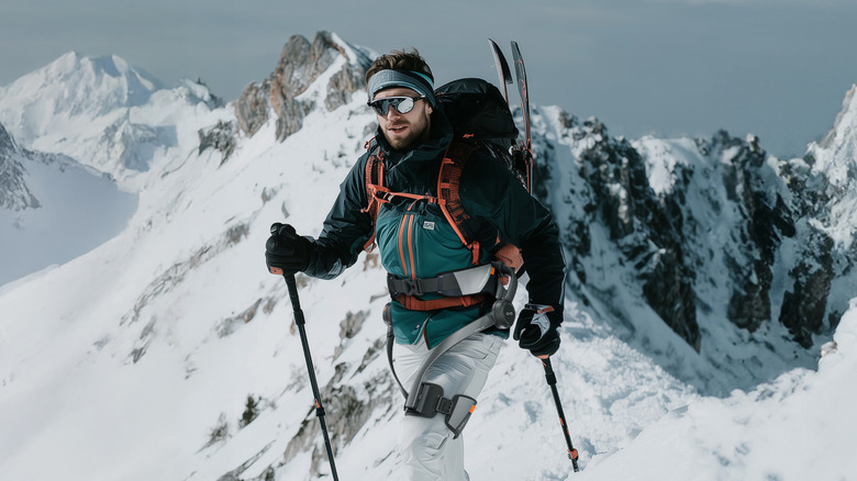 Backpacker wearing Hypershell Exoskeleton while walking in mountainous region