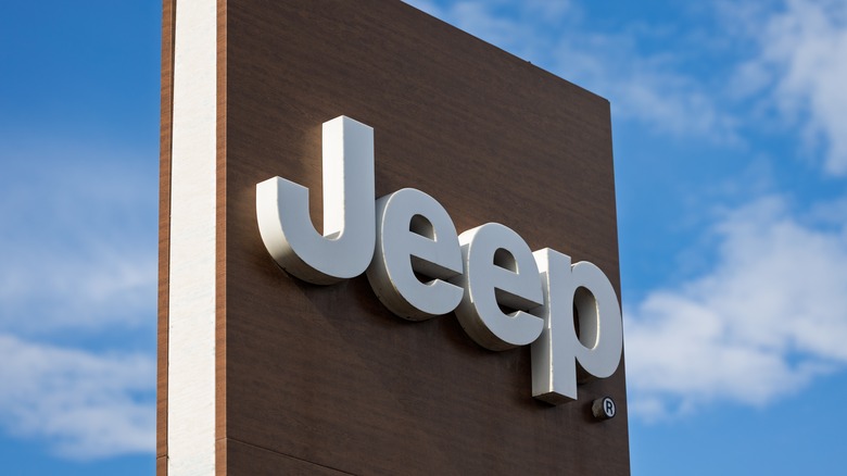 Picture displaying Jeep logo in cloudy sky