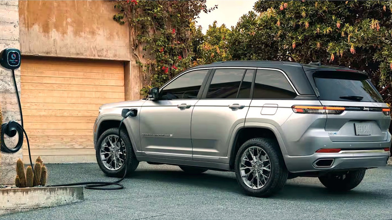 Person plugging Jeep Hybrid into charging station